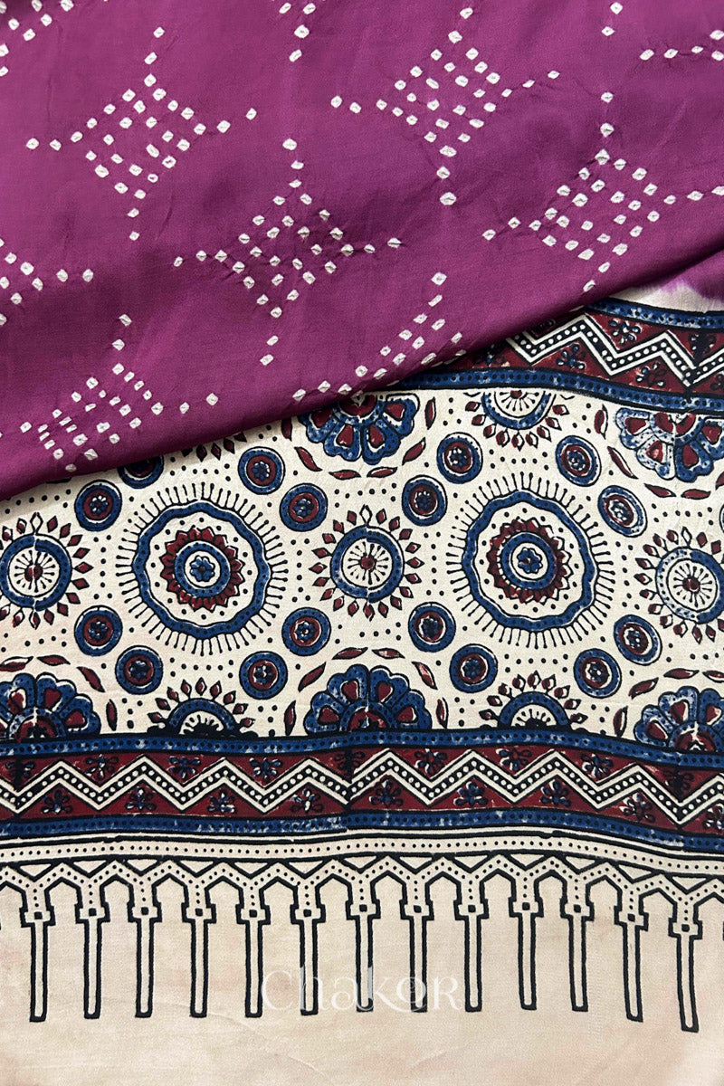 Hand tied  Magenta Bandhani patterns on modal stole with contrast  Off-white Ajrakh pallu detail.
