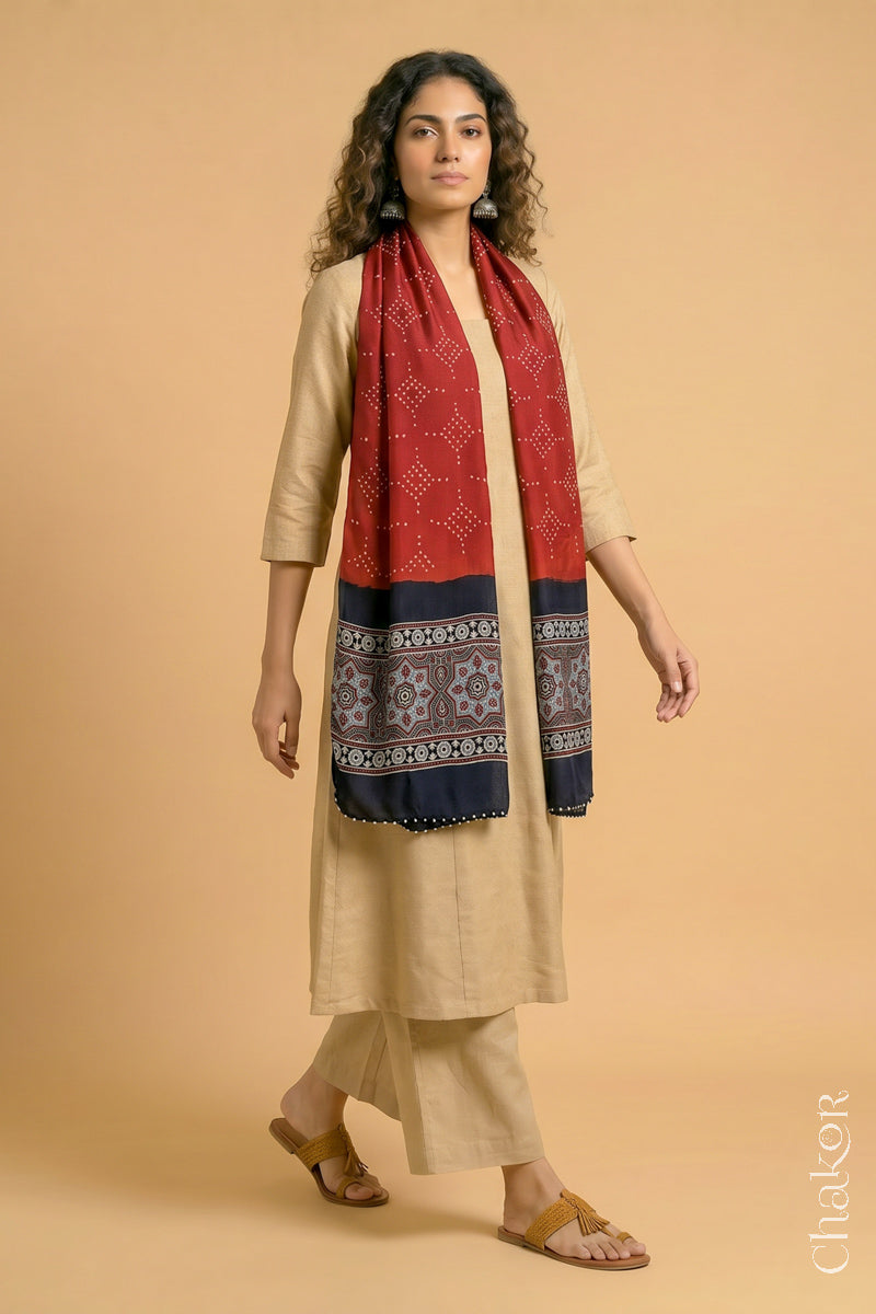 Full length view of handcrafted Red Bandhani modal stole with iron  black ajrakh pallu worn as dupatta wrapped around the neck.
