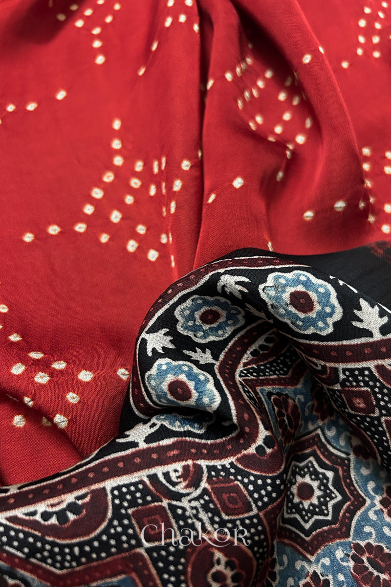 Close up of natural dye black Ajrakh print on handcrafted stole with intricate block printed motifs and delicate bandhani patterns.
