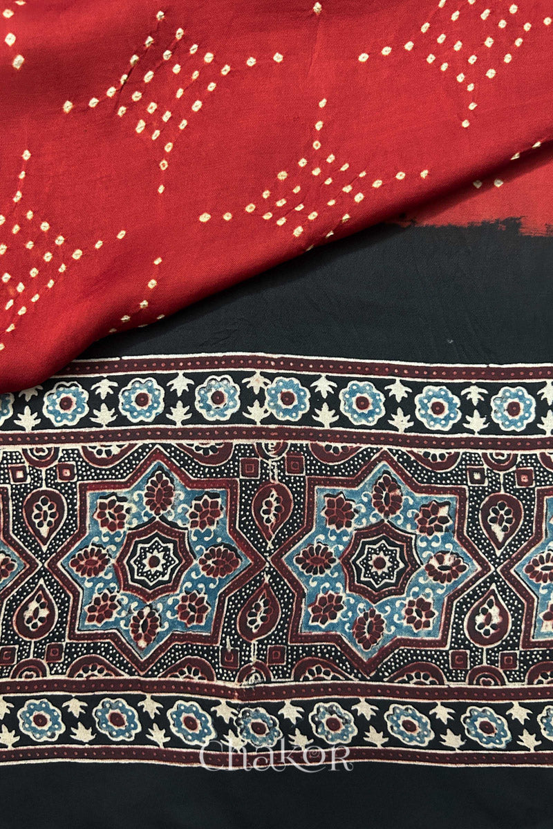 Detailed Ajrakh pattern on modal stole showing traditional hand block printing and intricate bandhani motifs.
