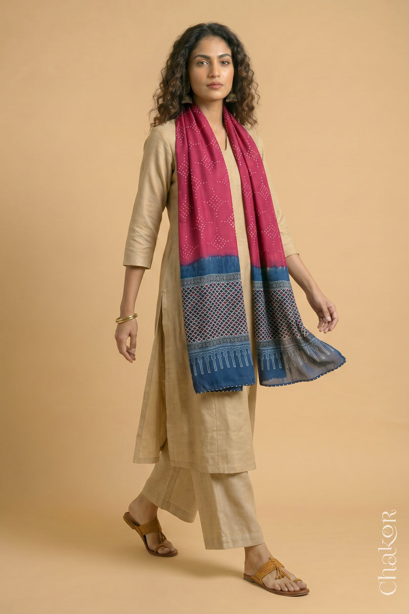 Full length view of handcrafted  Strawberry Pink Bandhani stole with Indigo Ajrakh pallu worn as dupatta wrapped around the neck.
