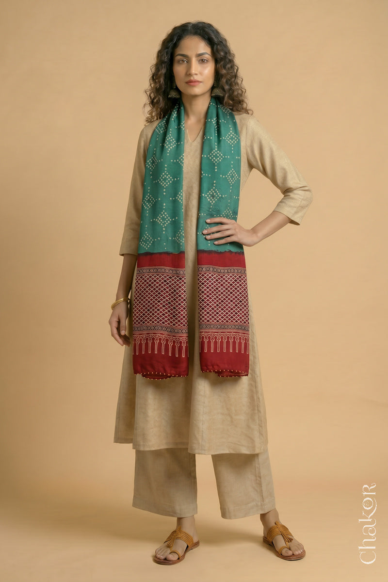 Handcrafted Bandhani Ajrakh modal stole draped on model with Turle Green Bandhani body and Madder Red Ajrakh pallu.
