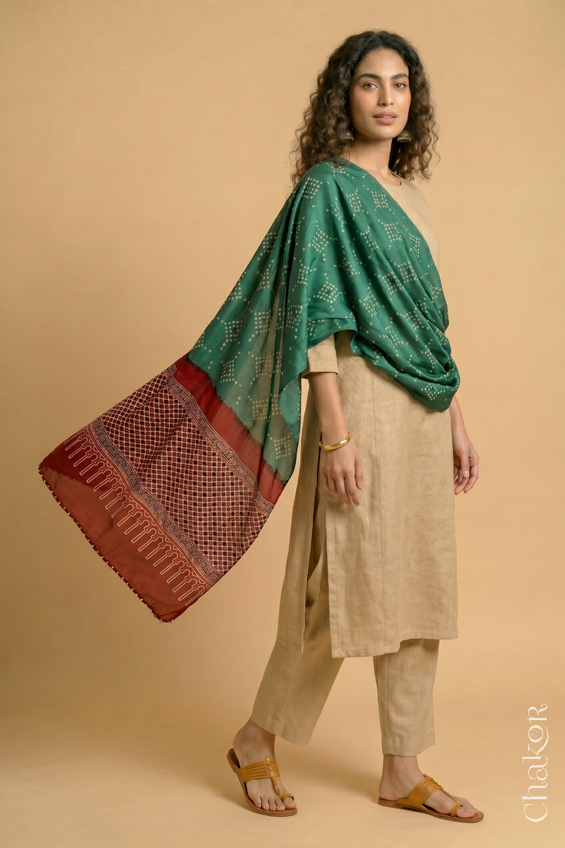 Flowing Turtle Green modal Bandhani stole with Madder Red Ajrakh pallu showing movement and lightweight drape.
