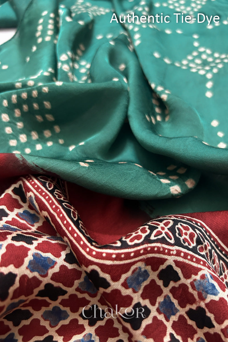 Turtle Green Hand tied Bandhani dots on modal stole with contrast ajrakh pallu detail showcasing fabric texture and softness.
