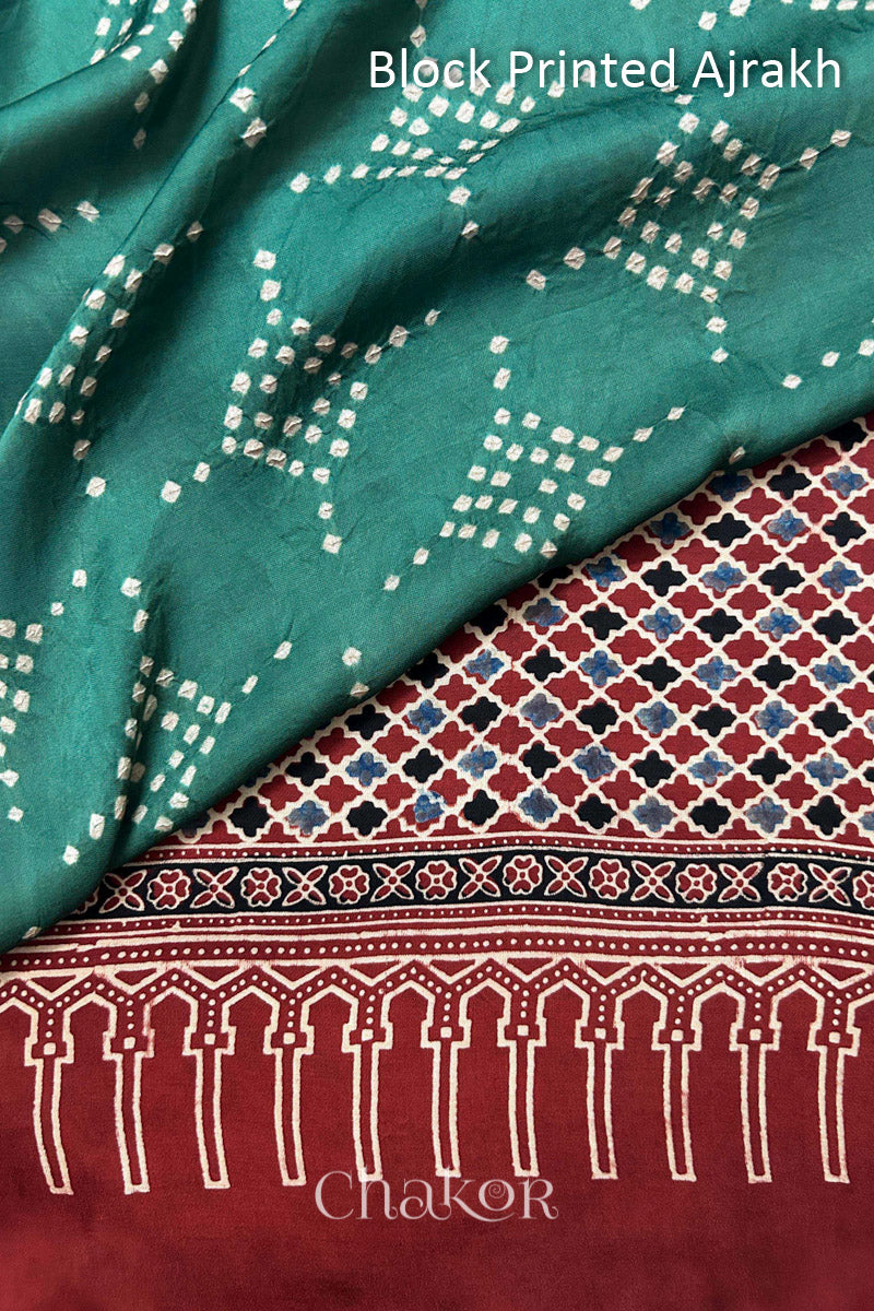 Hand tied Turtle Green Bandhani patterns on modal stole with contrast Manjistha Red Ajrakh pallu detail.
