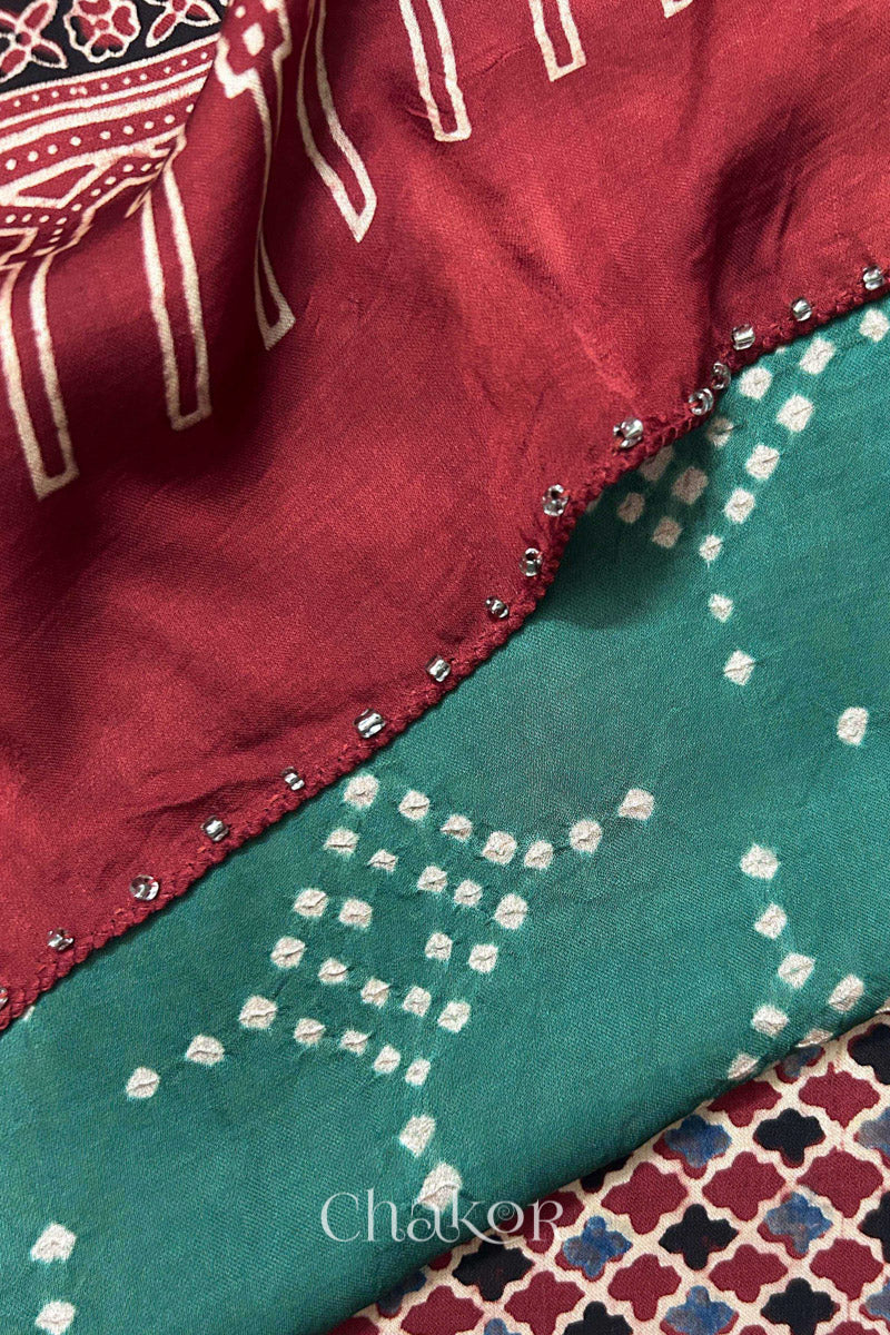Turtle Green Bandhani and Madder Red Ajrakh combination modal stole with glass bead edging detail on pallu end.
