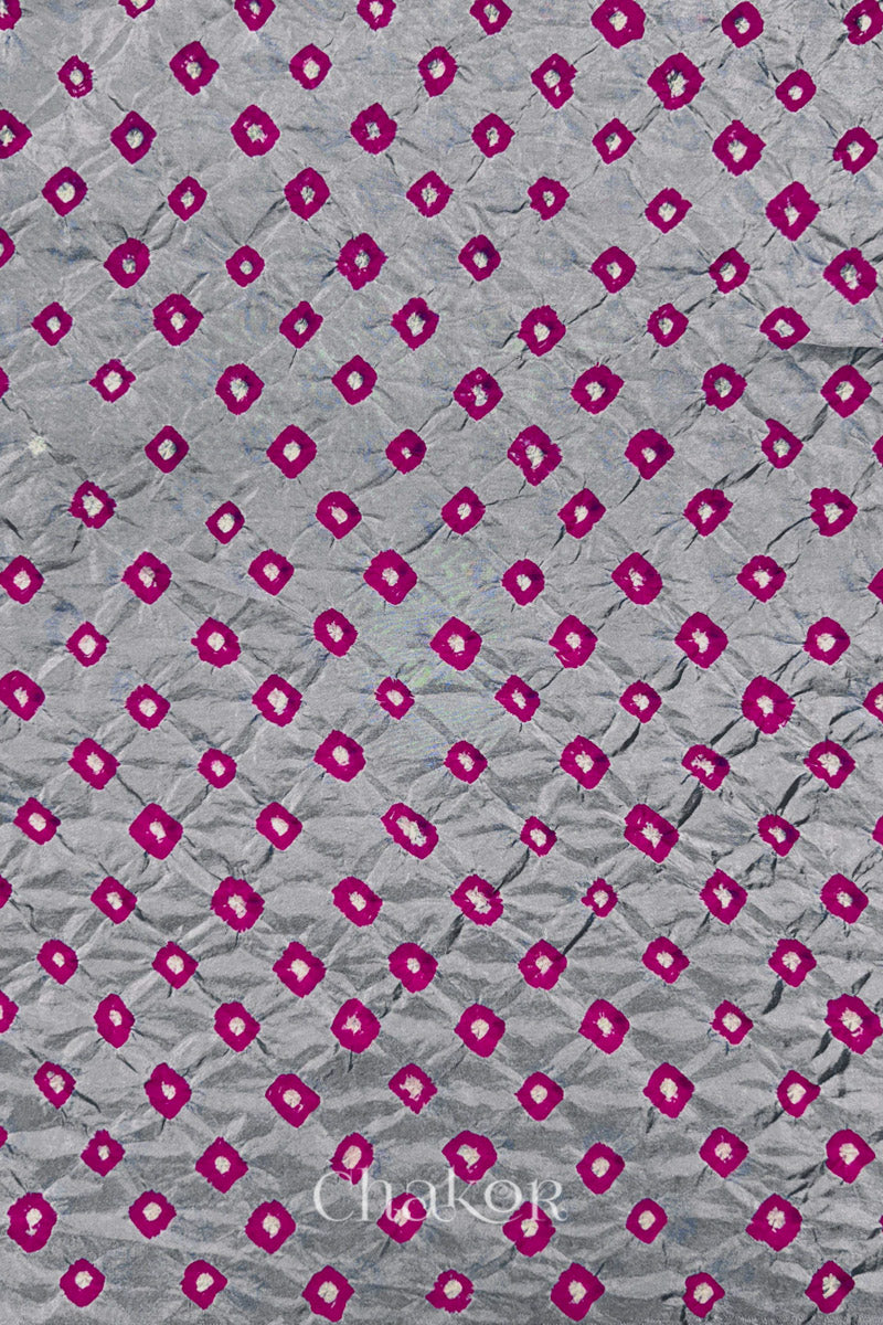 Light Grey Mulberry silk fabric showcasing dual colour Pink bandhani patterns and Chakor brand watermark.
