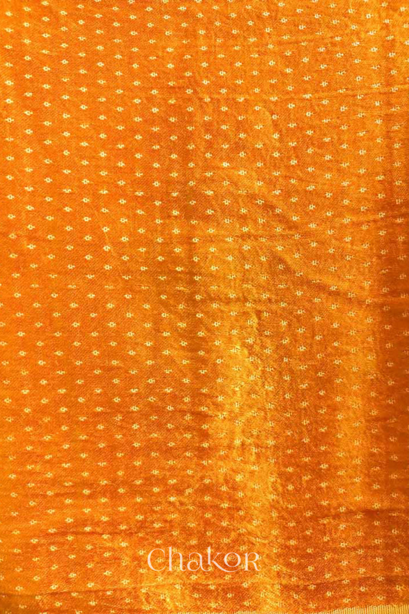 Close up of Handcrafted Haldi Yellow Mashru Blouse Fabric with self woven design and silky texture.