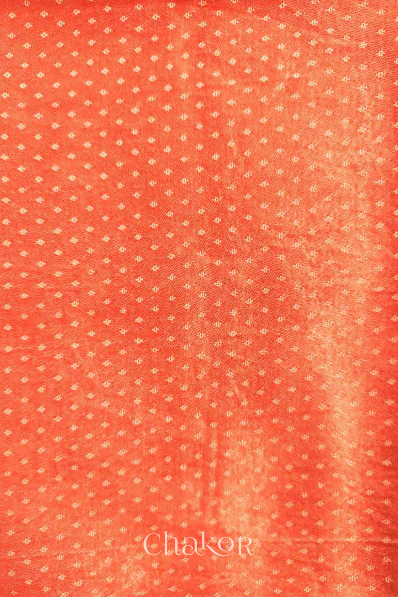 Close up of Handcrafted Peach Mashru Blouse Fabric with self woven design and silky texture.