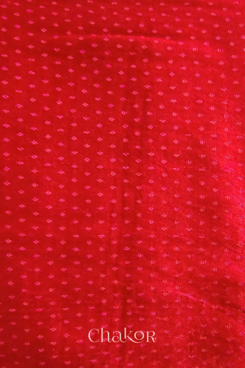 Close up of Red  Mashru Blouse Fabric with self woven design and silky texture.