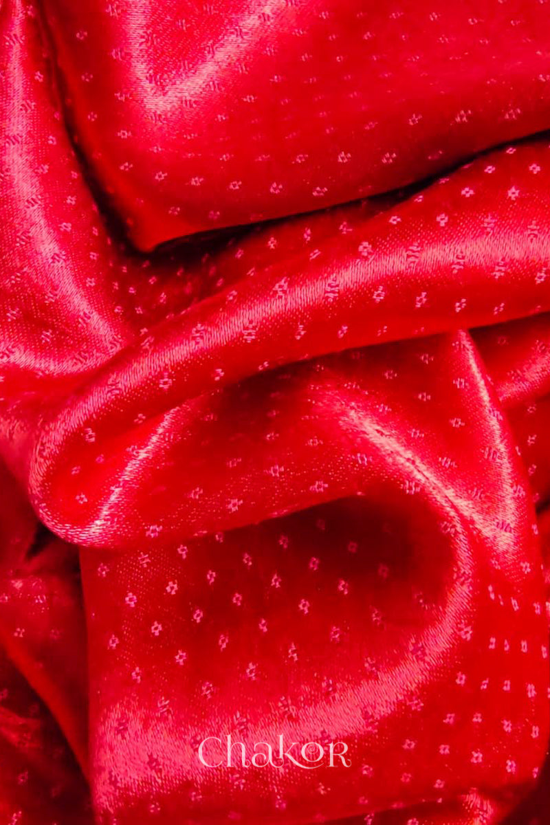 Close up of Red  Mashru Blouse Fabric with self woven design and silky texture.