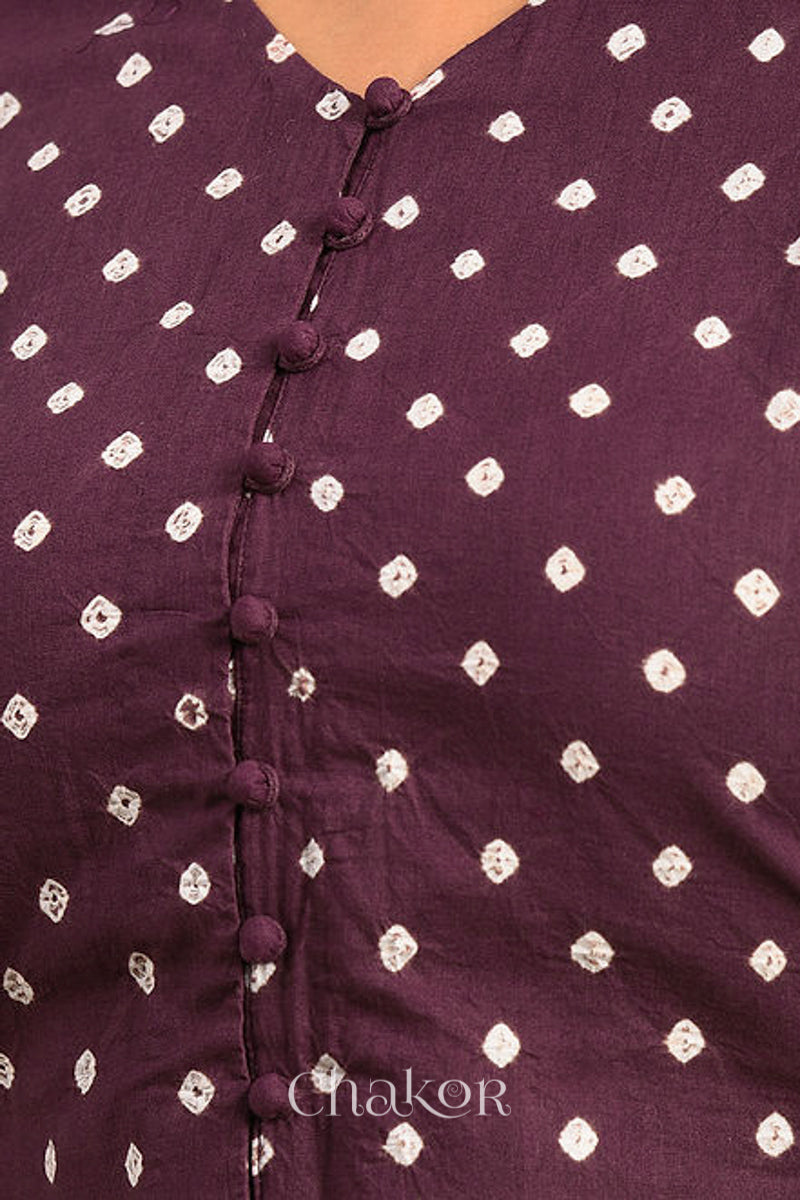 Woman wearing a handcrafted brown bandhani cotton blouse with intricate parrot motifs and boria buttons on front.
