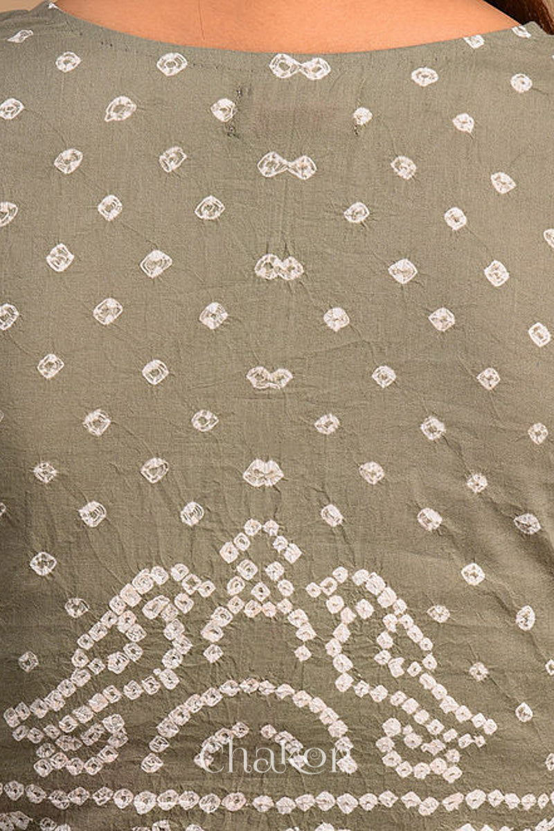 Woman wearing a handcrafted grey bandhani cotton blouse with intricate parrot motifs and boria buttons on front.