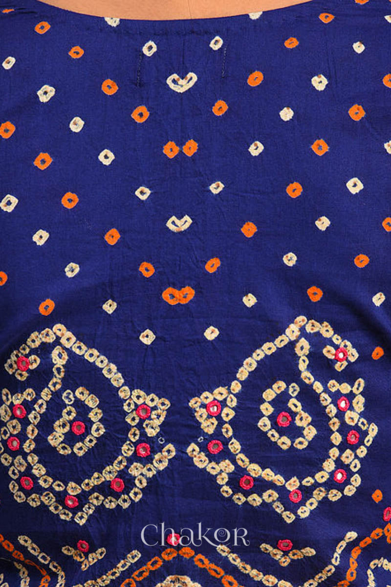 A woman wearing a traditional Navy Blue Bandhani Cotton Blouse with intricate mirror embroidered Keri - Paisley motifs and boria fabric buttons.