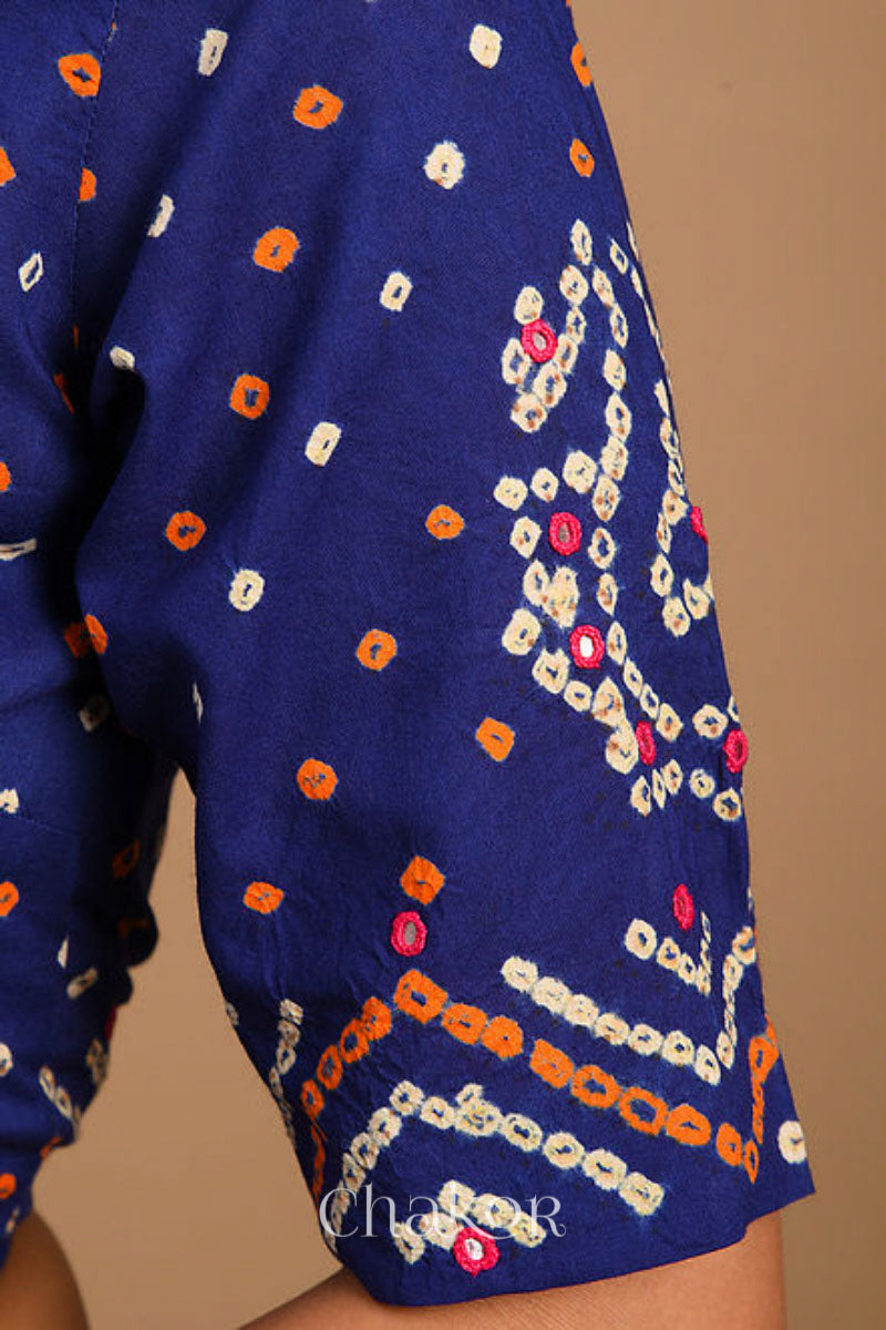 A woman wearing a traditional Navy Blue Bandhani Cotton Blouse with intricate mirror embroidered Keri - Paisley motifs and boria fabric buttons.