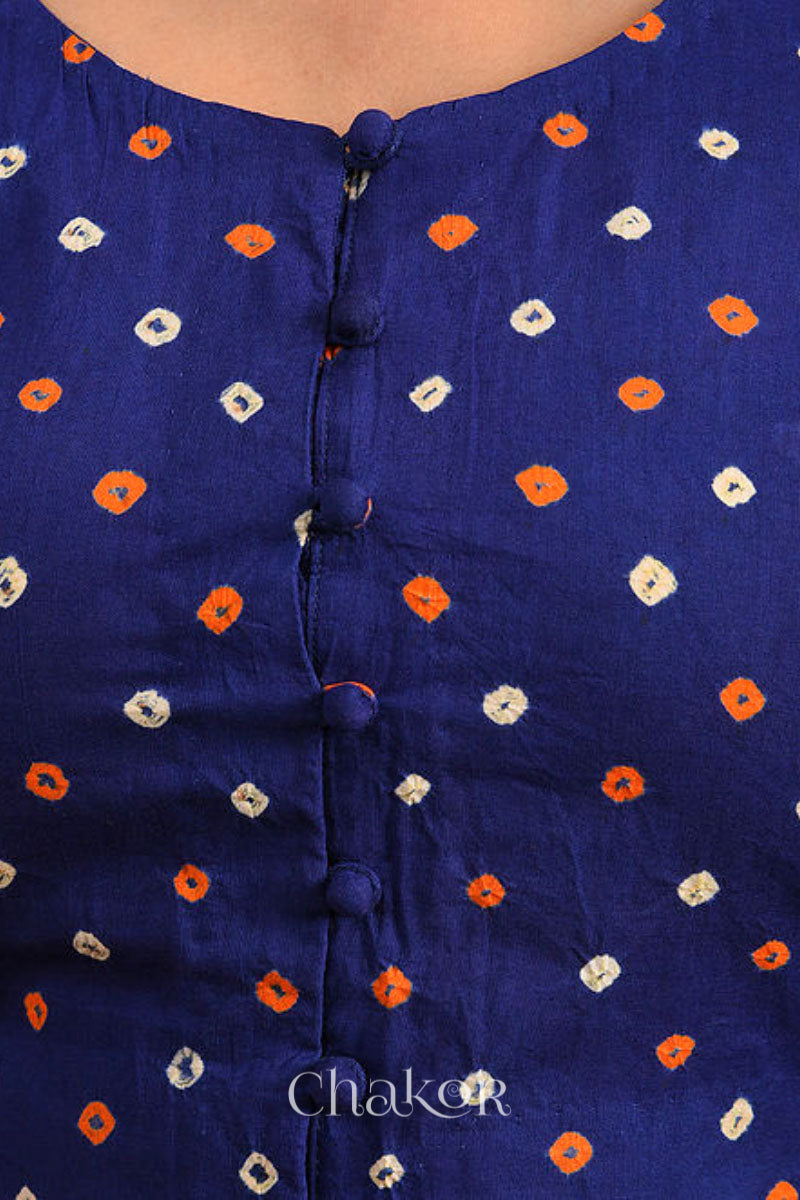 A woman wearing a traditional Navy Blue Bandhani Cotton Blouse with intricate mirror embroidered Keri - Paisley motifs and boria fabric buttons.