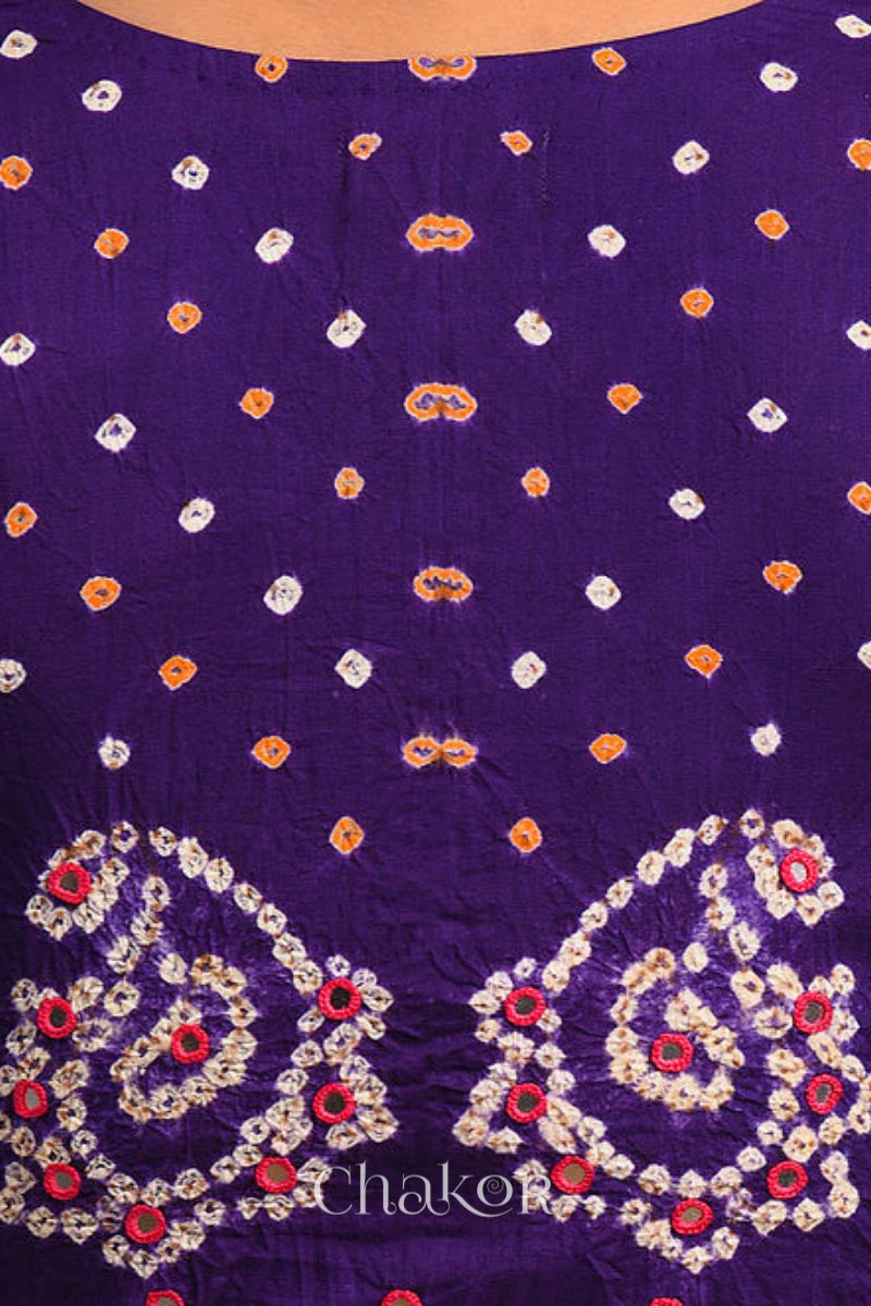 A woman wearing a traditional Purple Bandhani Cotton Blouse with intricate mirror embroidered Keri - Paisley motifs and boria fabric buttons.