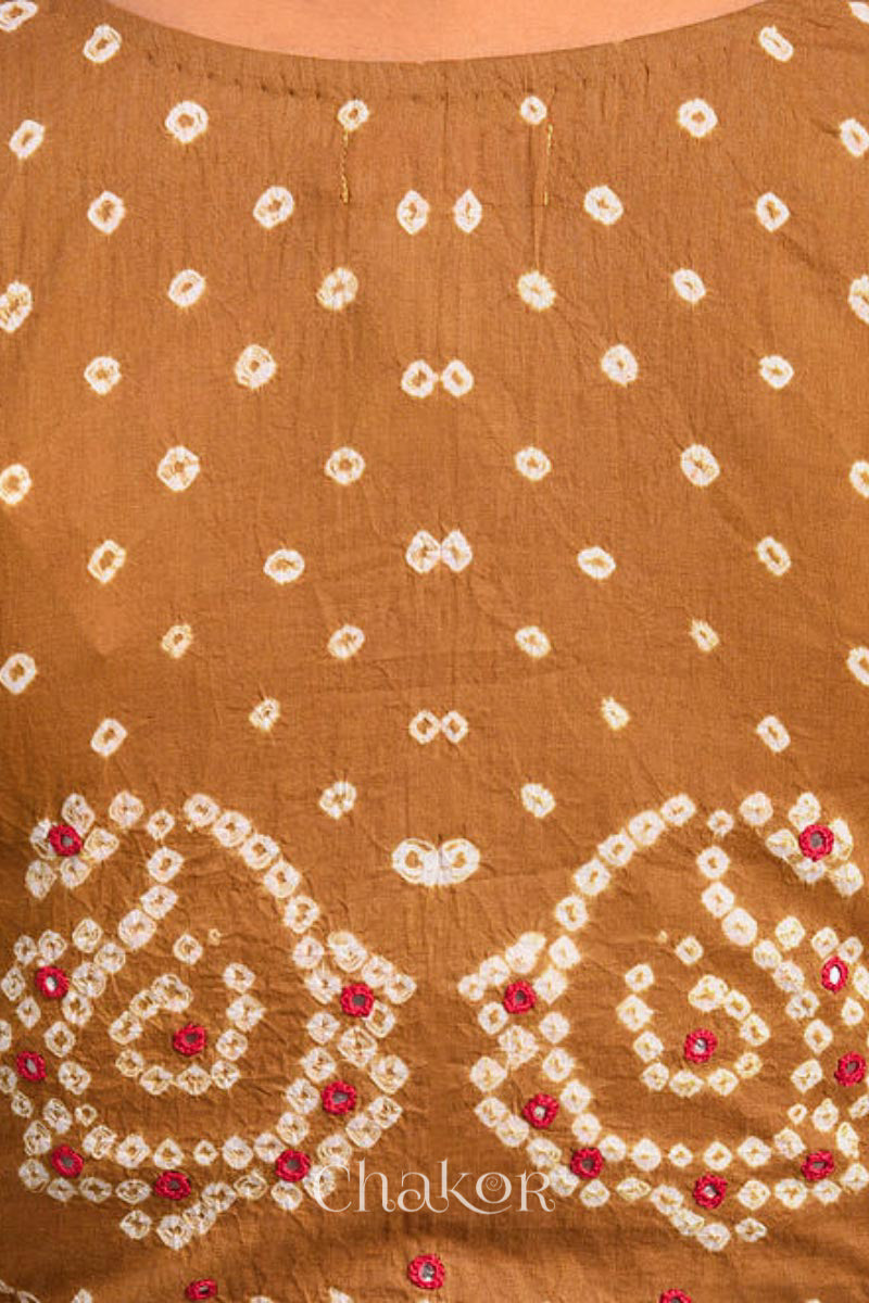 A woman wearing a traditional Mustard Yellow Bandhani Cotton Blouse with intricate mirror embroidered Keri - Paisley motifs and boria fabric buttons.