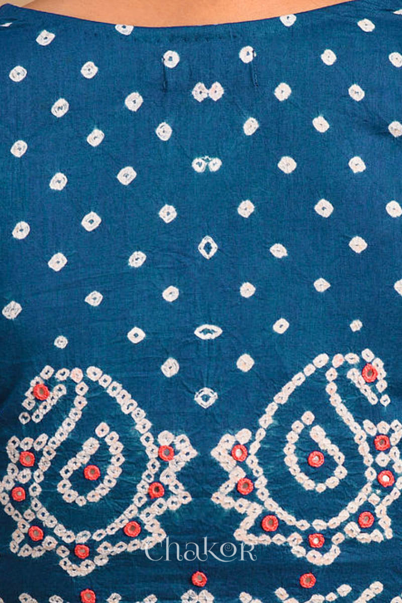 A woman wearing a traditional Indigo Blue Bandhani Cotton Blouse with intricate mirror embroidered Keri - Paisley motifs and boria fabric buttons.