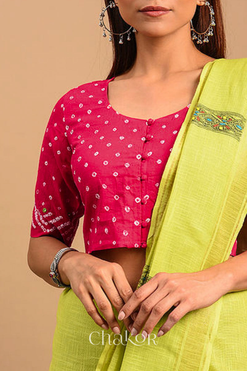 A woman wearing a traditional Strawberry Pink Bandhani Cotton Blouse with intricate mirror embroidered Keri - Paisley motifs and boria fabric buttons.