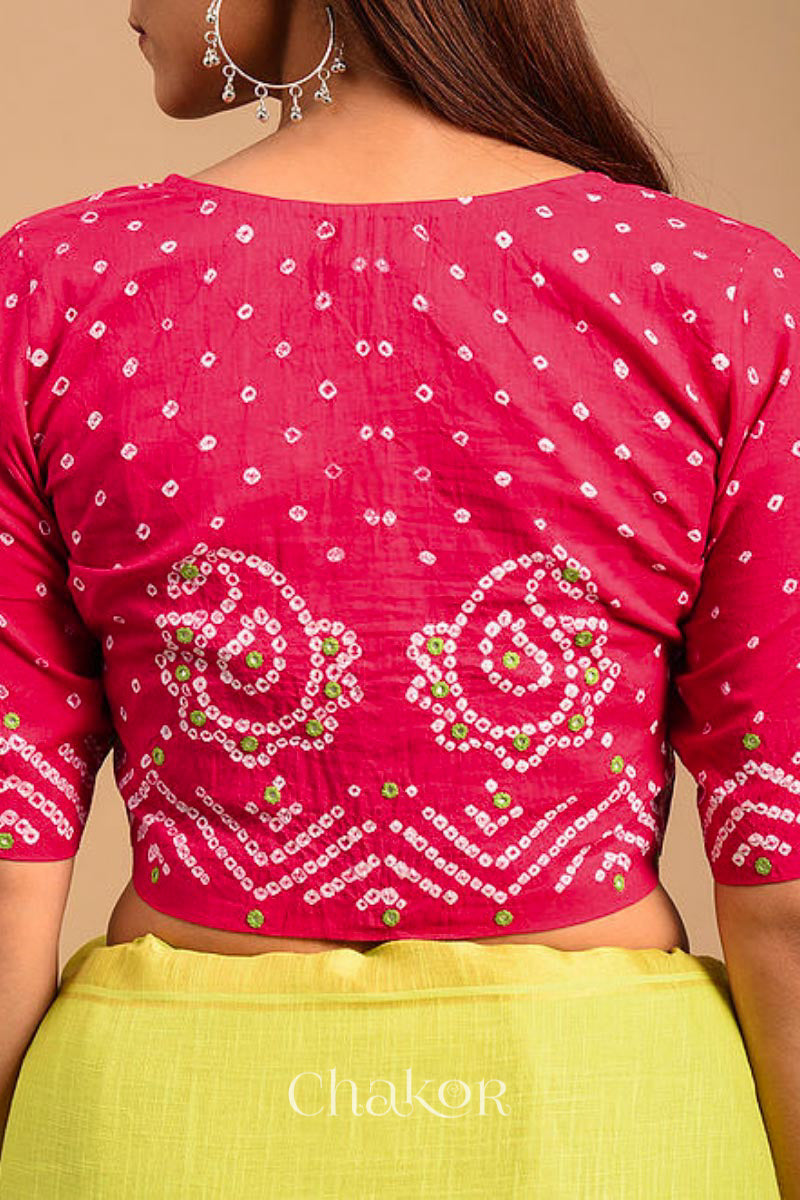 A woman wearing a traditional Strawberry Pink Bandhani Cotton Blouse with intricate mirror embroidered Keri - Paisley motifs and boria fabric buttons.