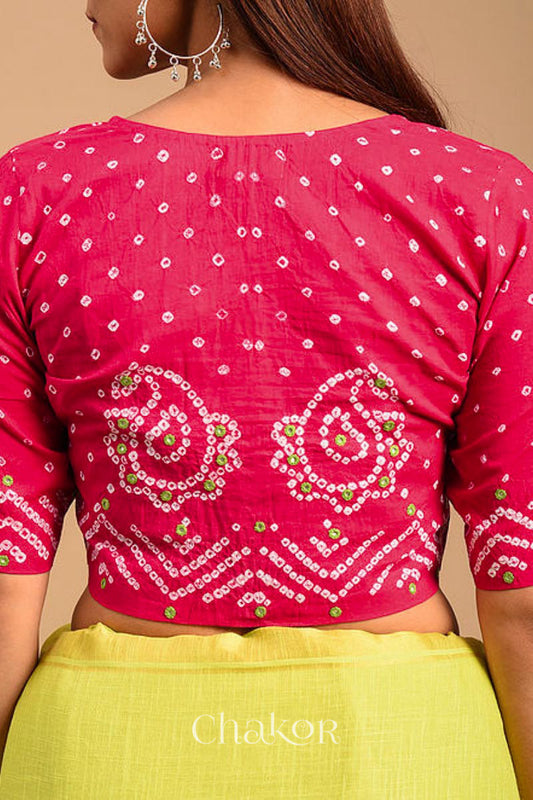 A woman wearing a traditional Strawberry Pink Bandhani Cotton Blouse with intricate mirror embroidered Keri - Paisley motifs and boria fabric buttons.